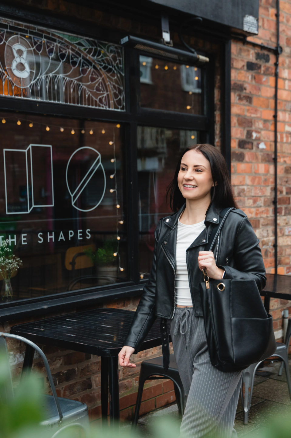 Rebecca walking by a cafe