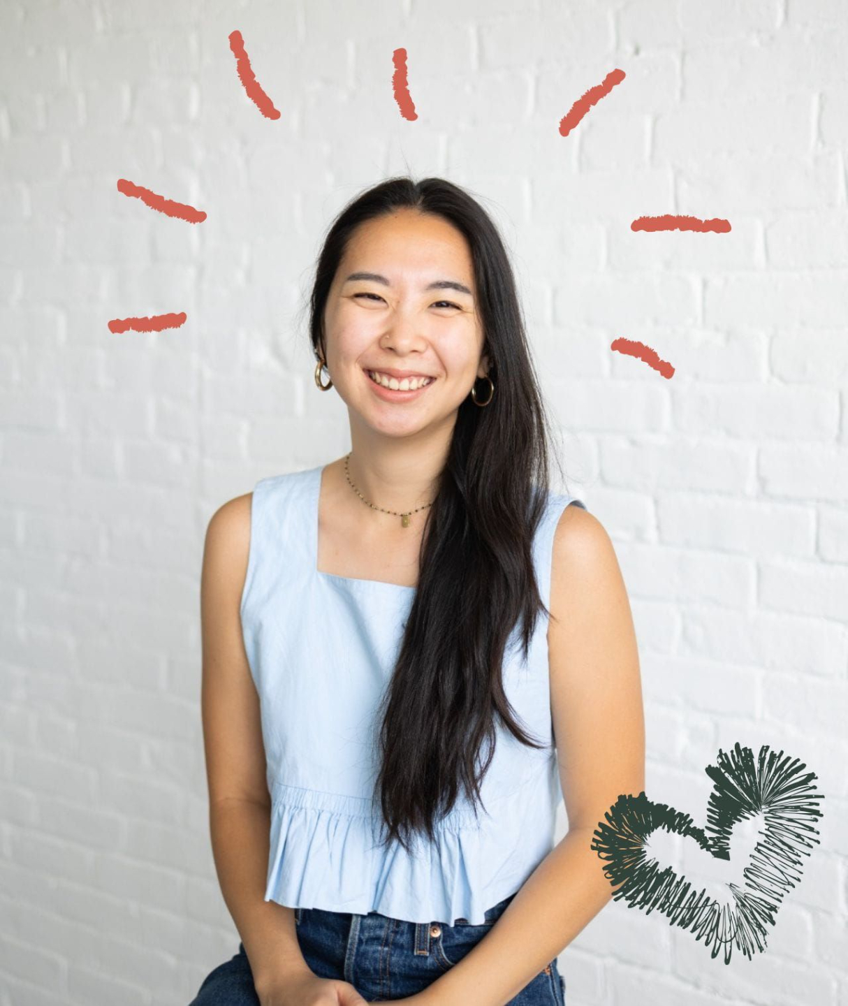 Someone wirting in a notebook while also look at another book. A laptop and coffee mug are on their table.