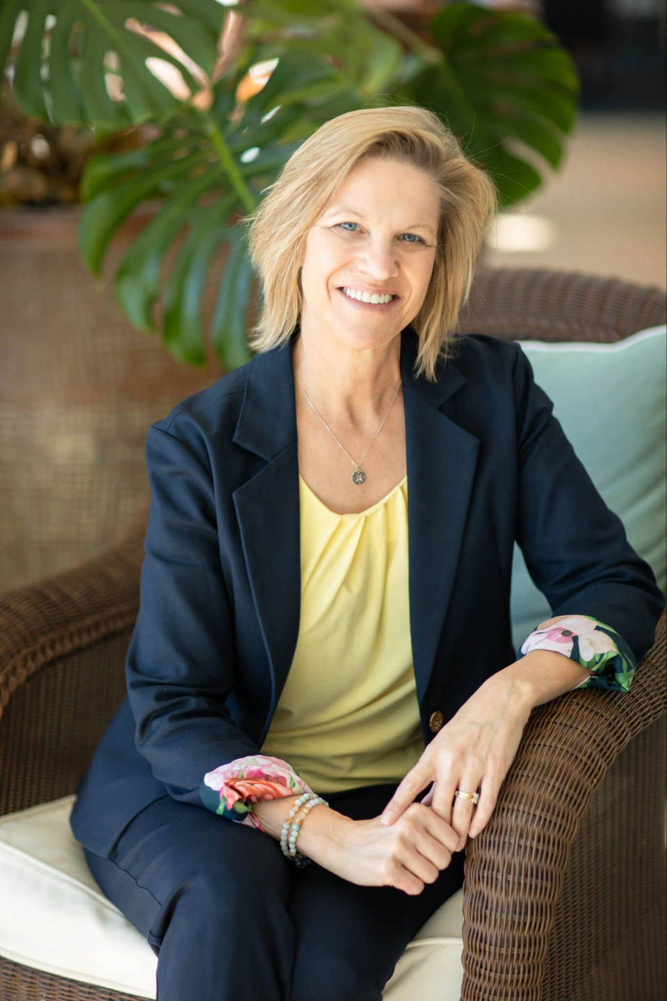 Smiling woman in a day dress representing Alive with Purpose coaching services.