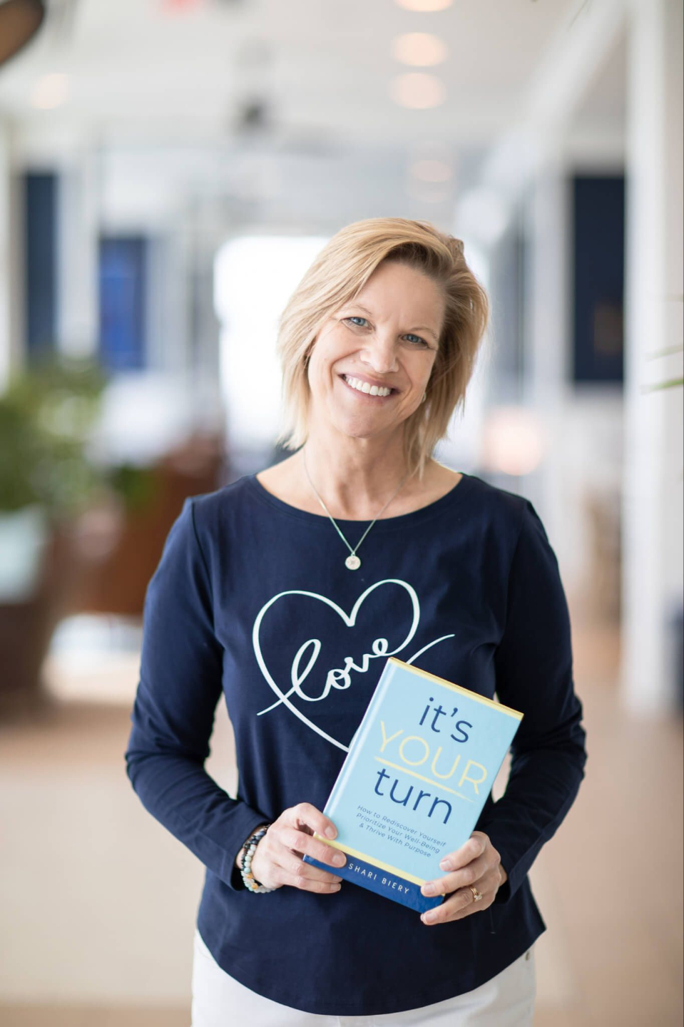 Happy health and wellness coach, Shari Biery, catering to midlife women.