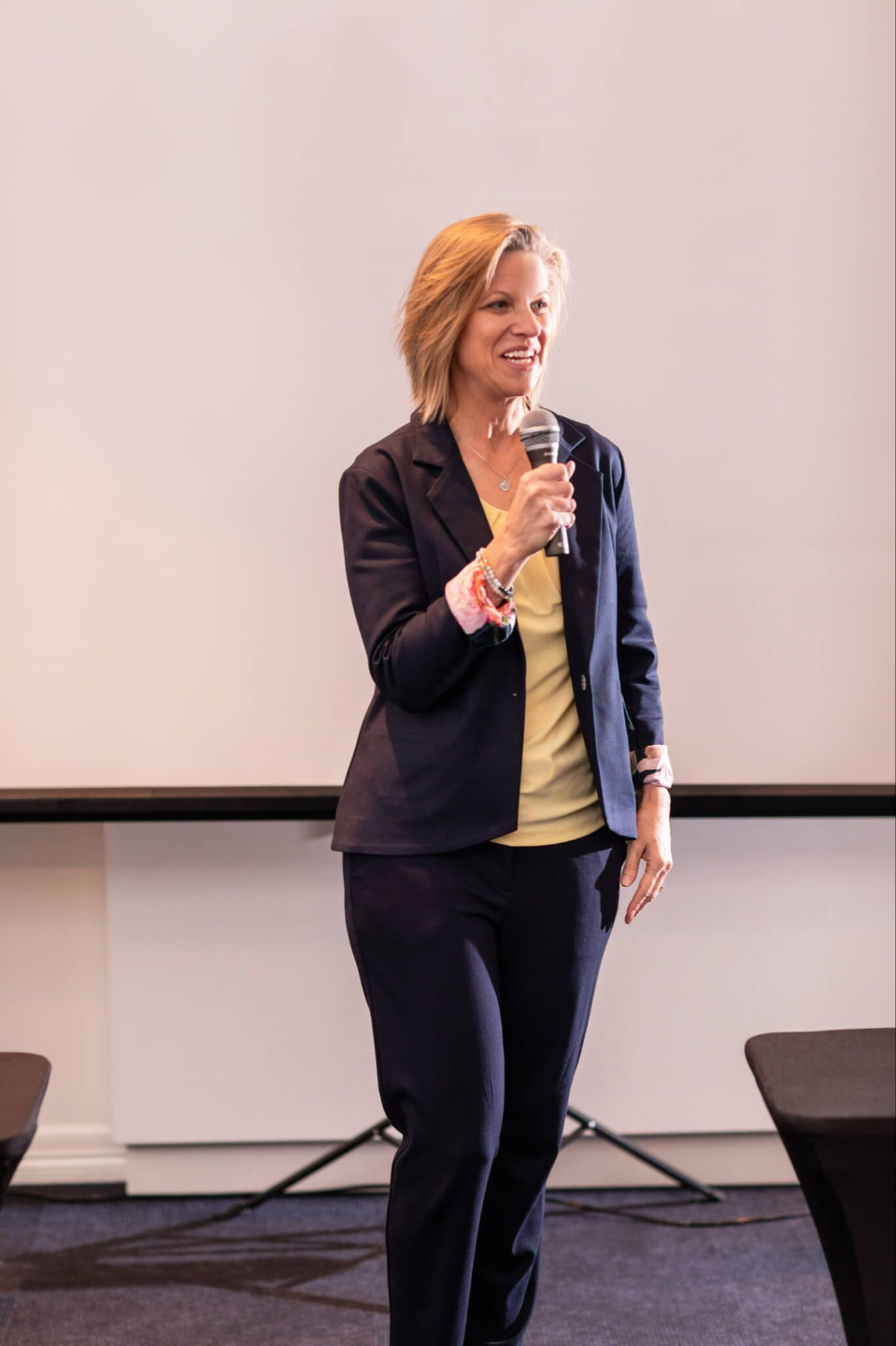 Shari Biery smiling and working on laptop to assist midlife women