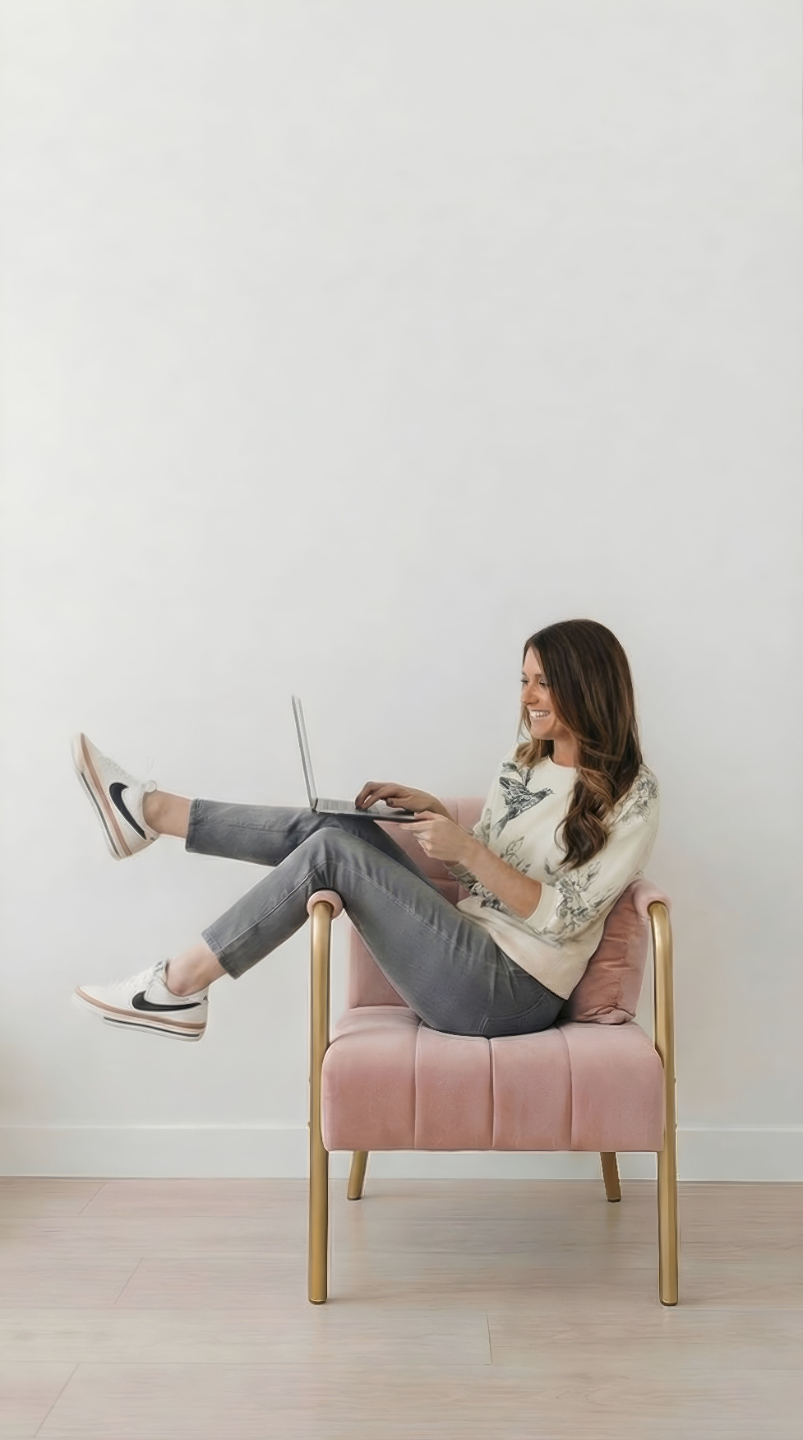 Amanda Corcoran, founder of PatternPAL Pro, sitting in a pink chair with laptop