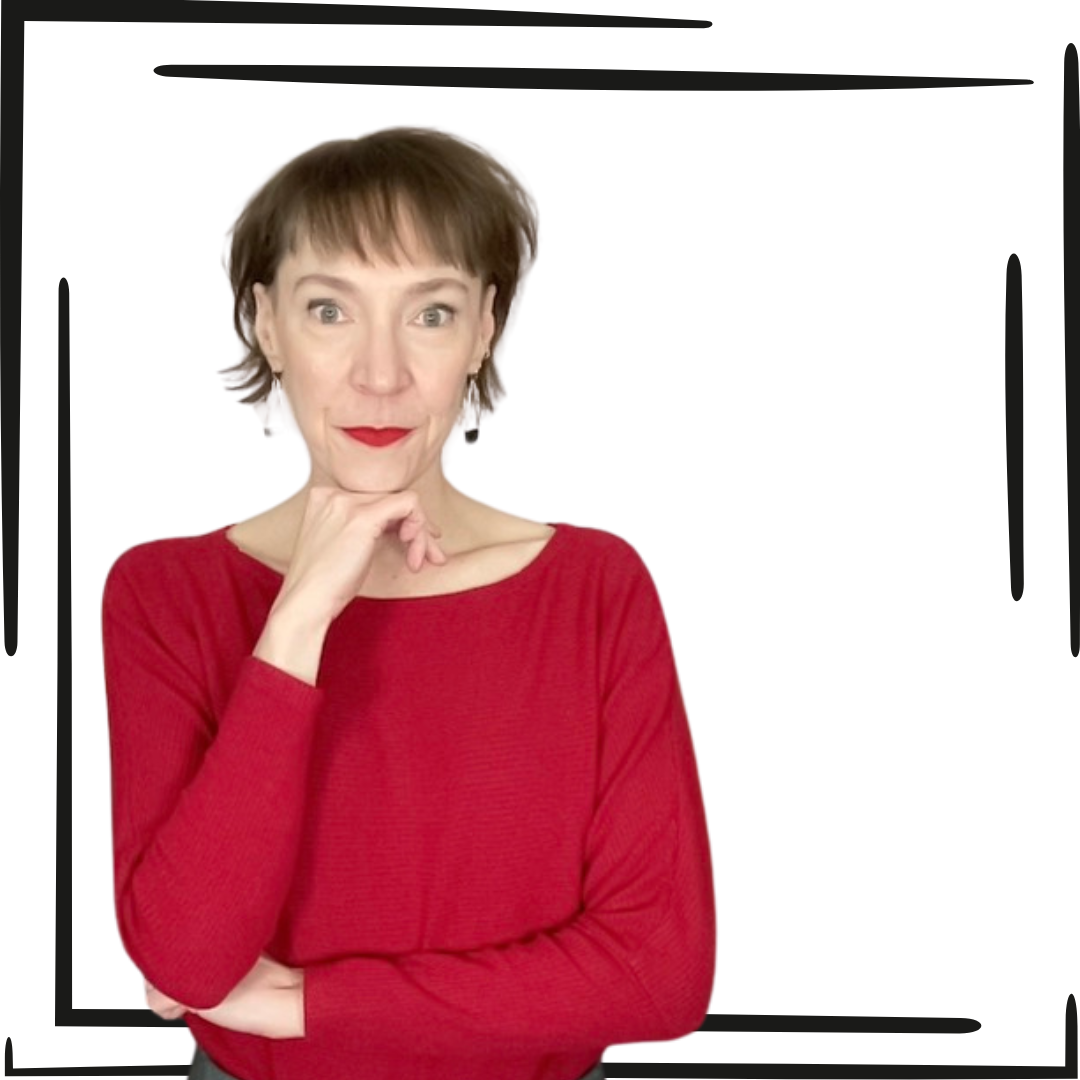 Picture of Penny in a red long sleeve shirt with her right hand under her chin looking directly at the camera with a closed mouth smile.