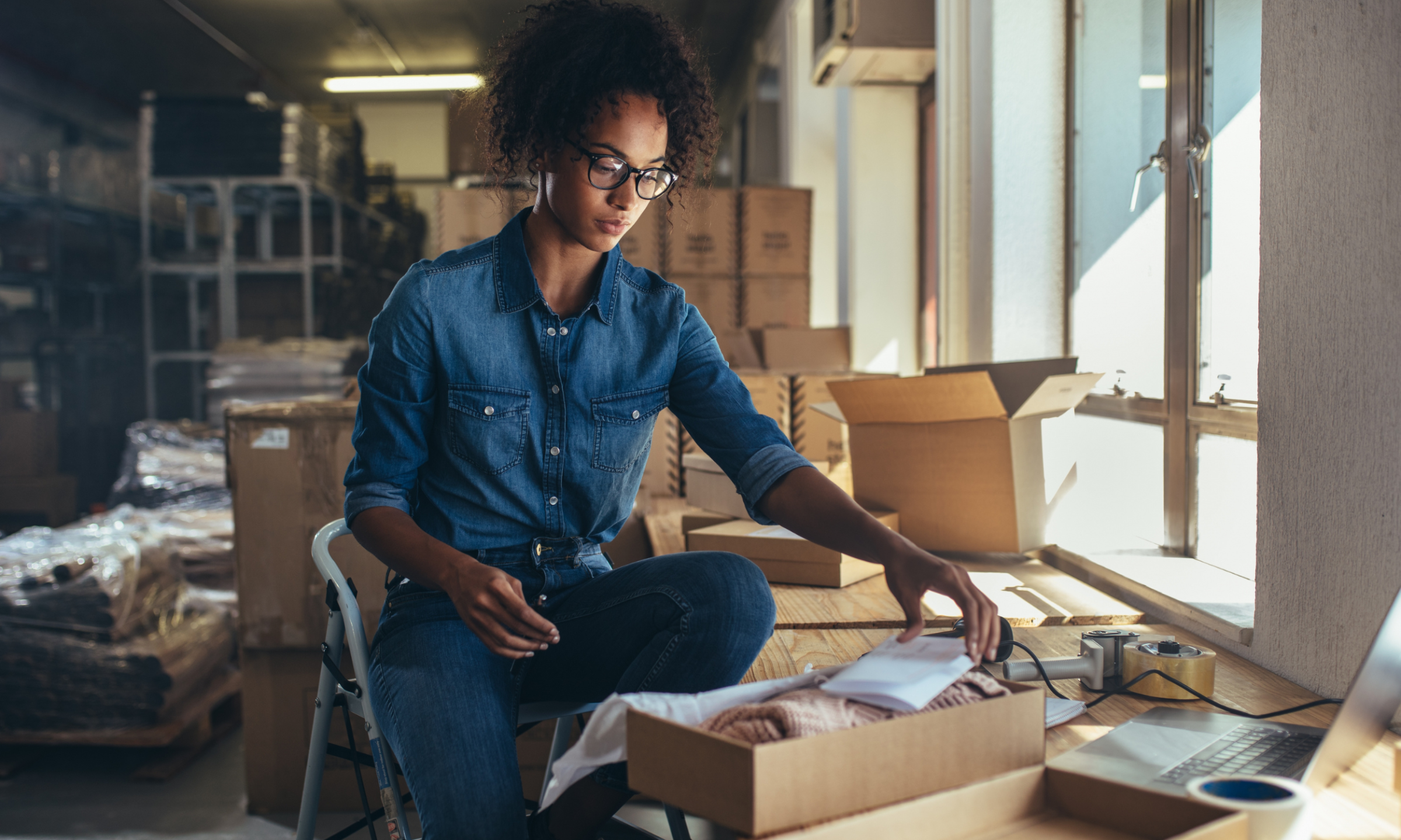 Small business owner packing product orders