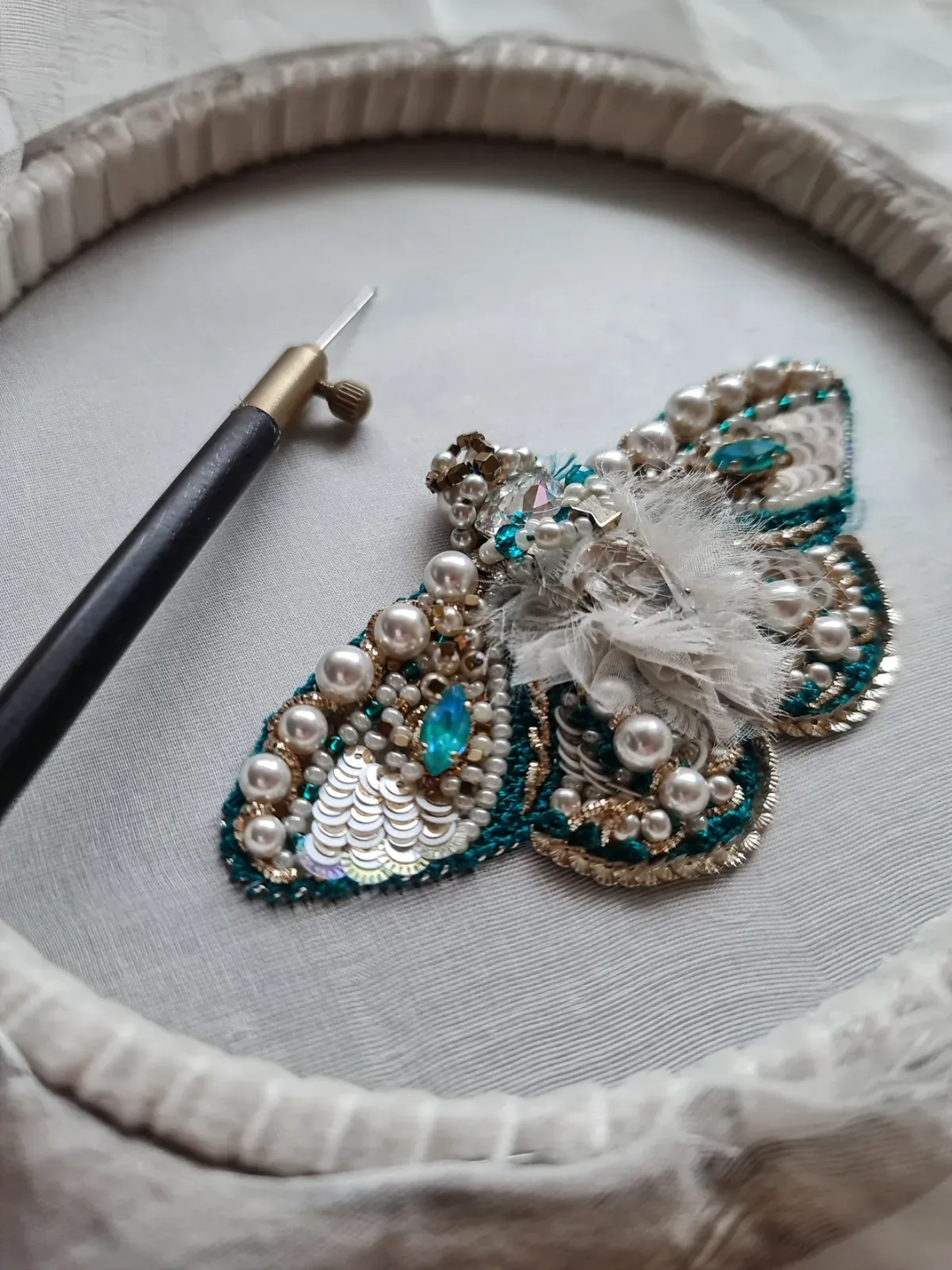 Beaded couture brooch on an embroidery hoop by Laura, student work from School of Couture