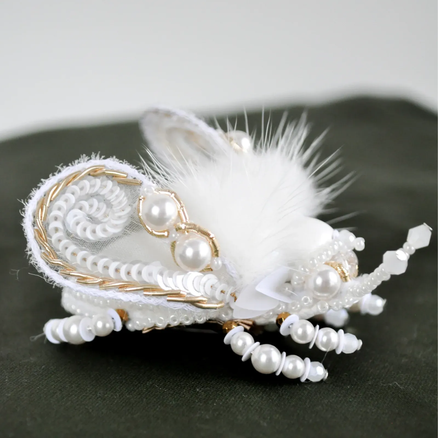 Pearl and feather embroidered beetle brooch, handmade couture piece by a School of Couture student