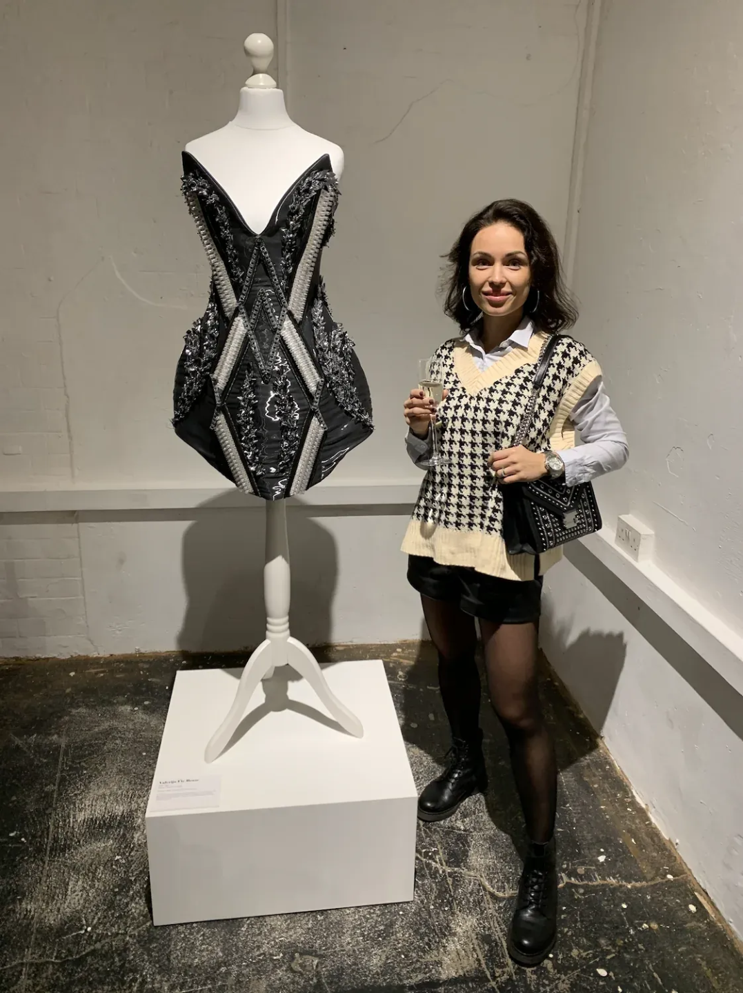 Valerija Fic beside a beaded couture bustier on a mannequin