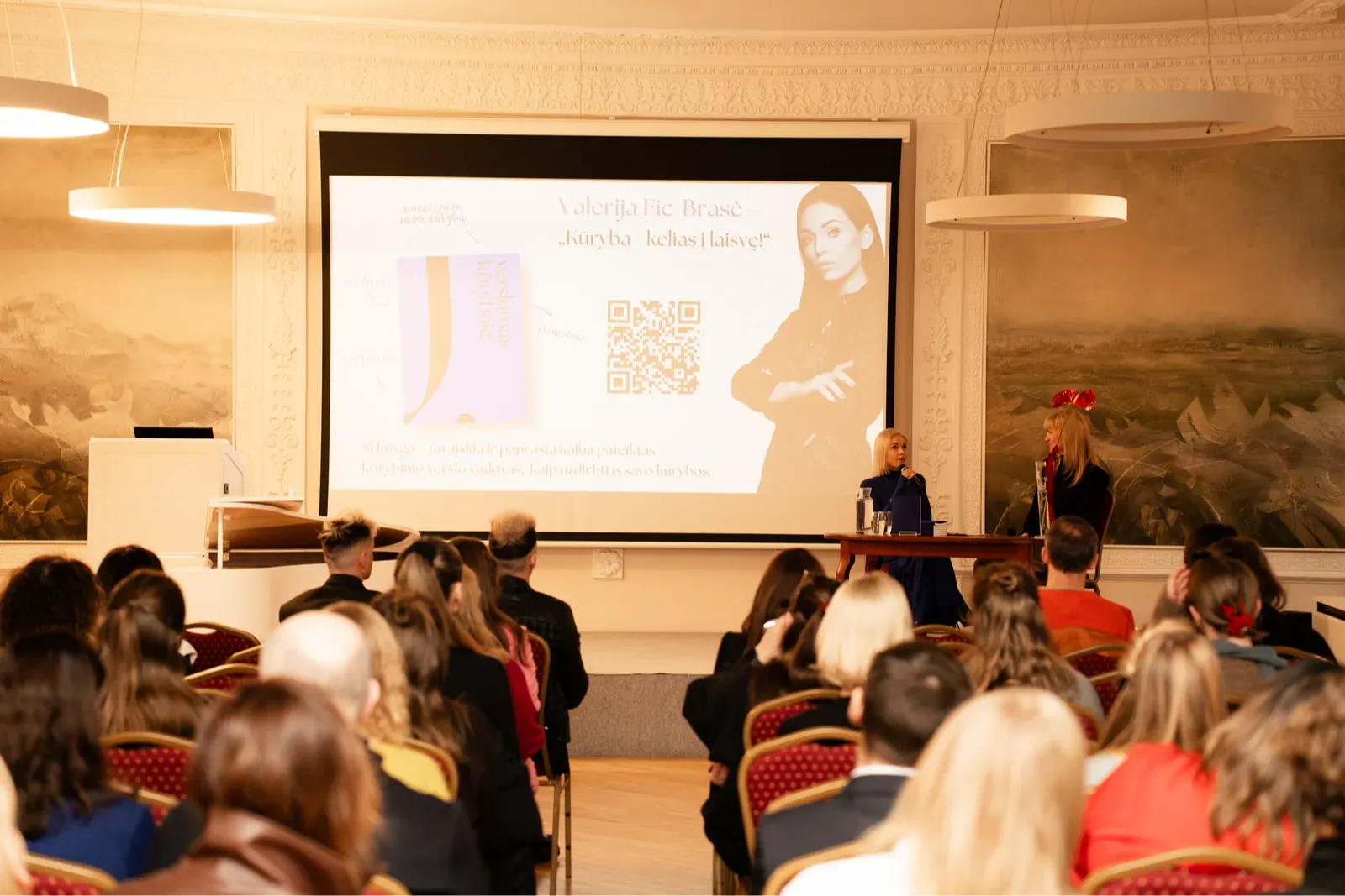 Valerija Fic Brasė presenting to an audience at a creative talk
