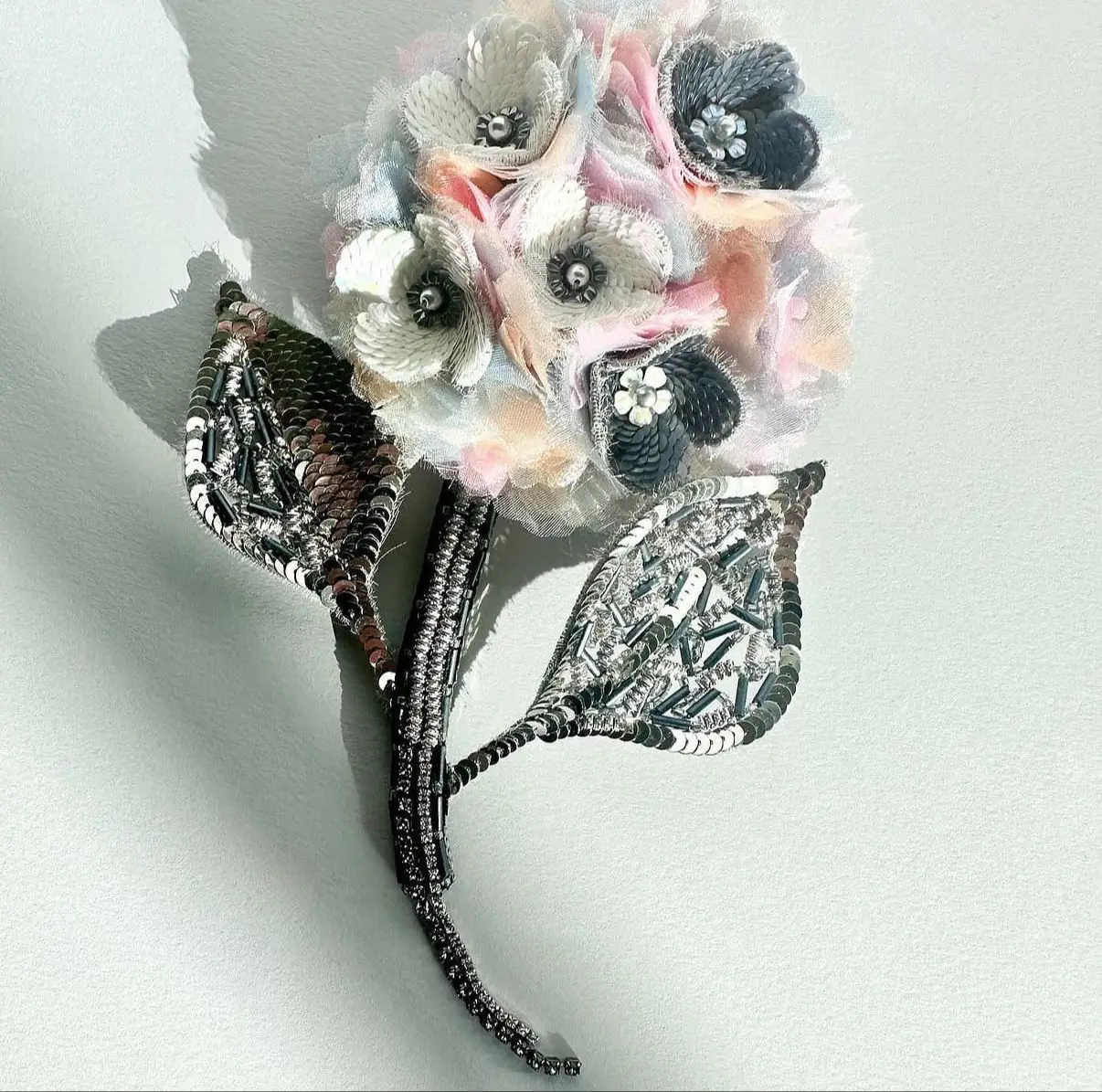 Student work from School of Couture course: hand-embroidered flower brooch with sequins and silk petals