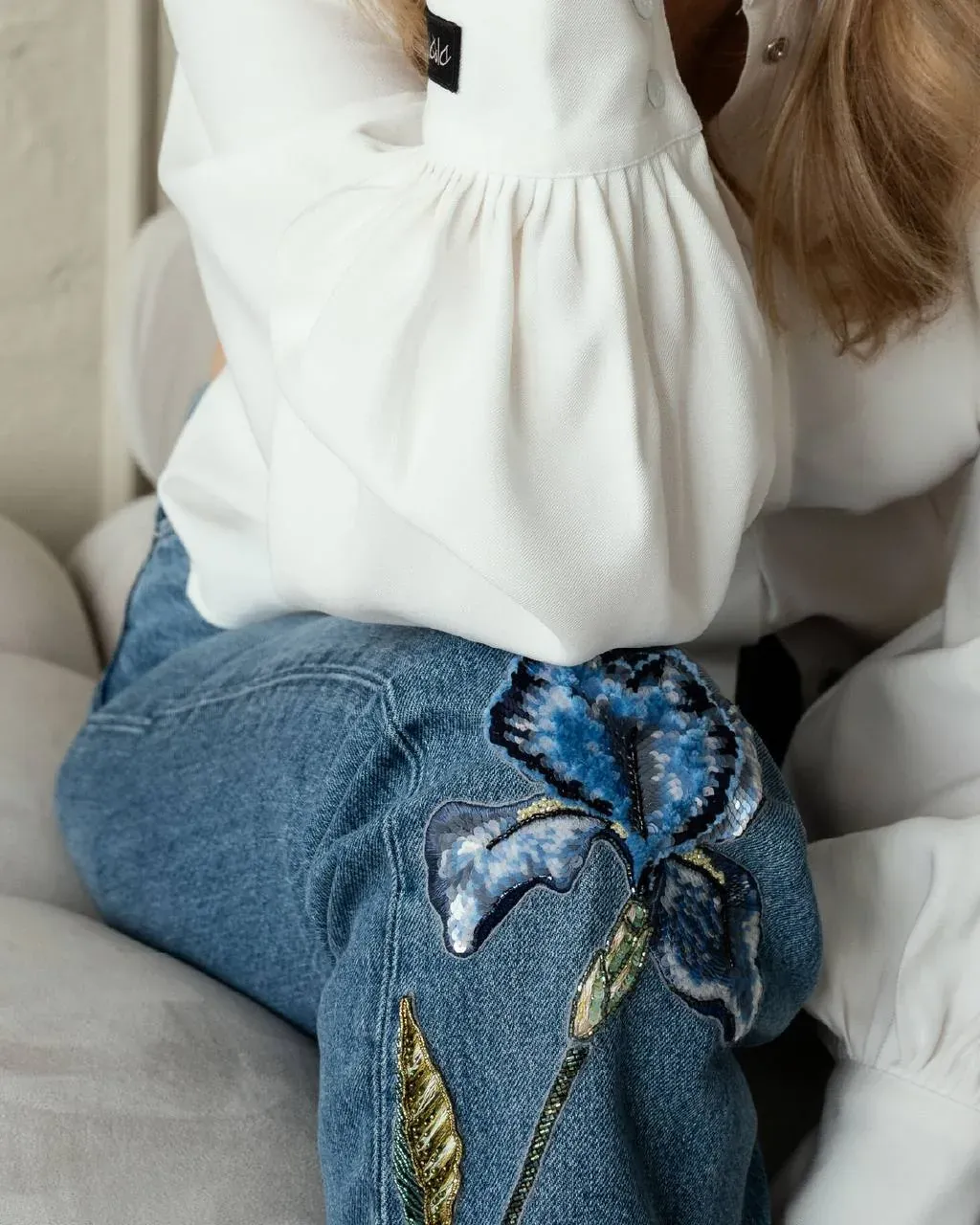 Blue butterfly embroidery appliqué on denim, student work from School of Couture courses