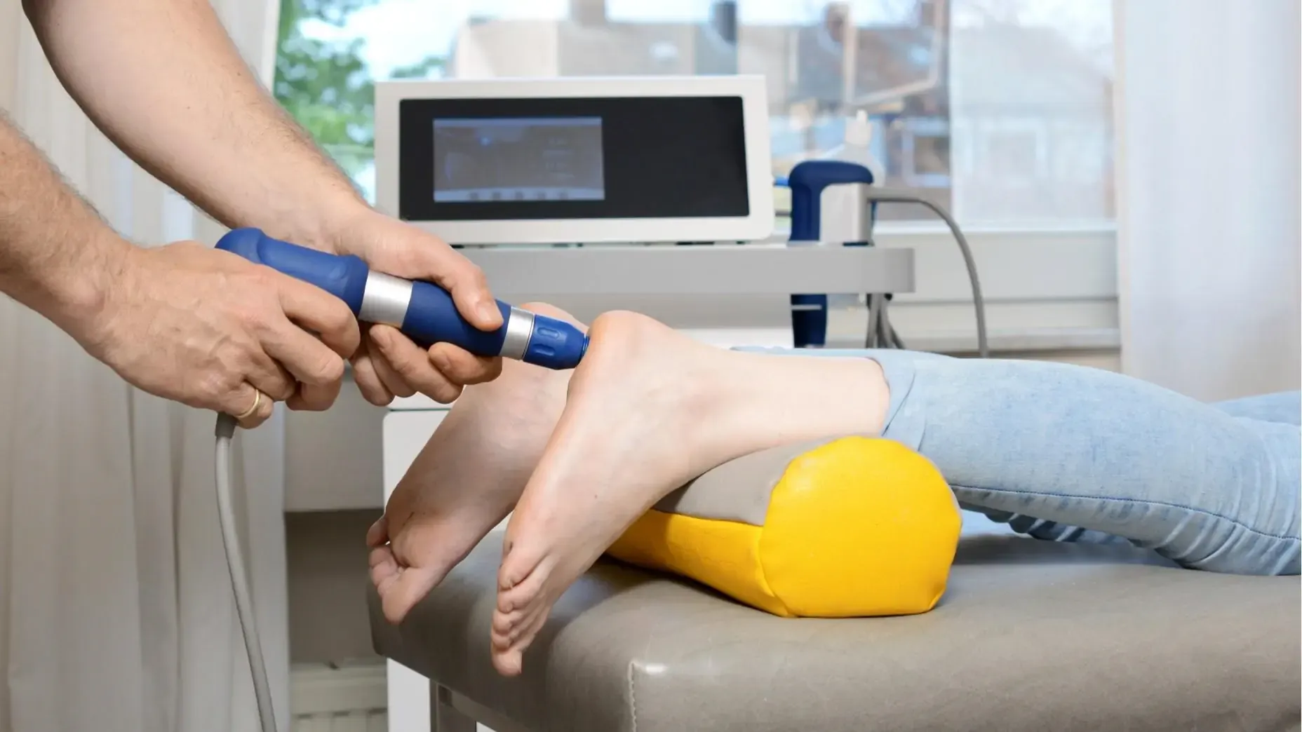 Clinician performing shockwave therapy on the heel