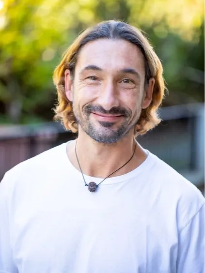 Close-up portrait of Dr. Nibodhi smiling warmly on the About page