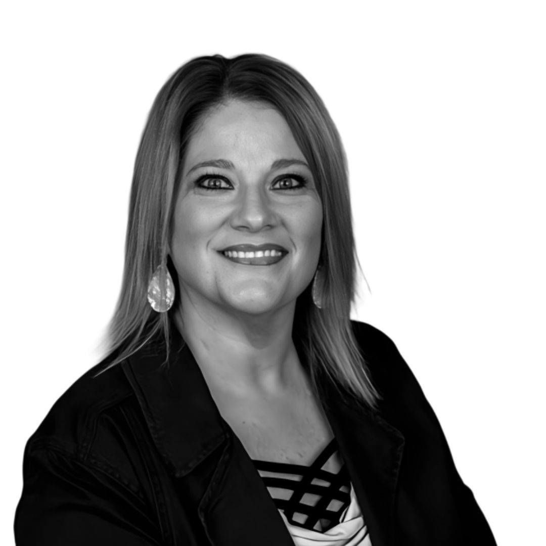 Smiling woman with straight shoulder-length hair wearing a dark blazer and large teardrop earrings, facing slightly to the side against a plain background