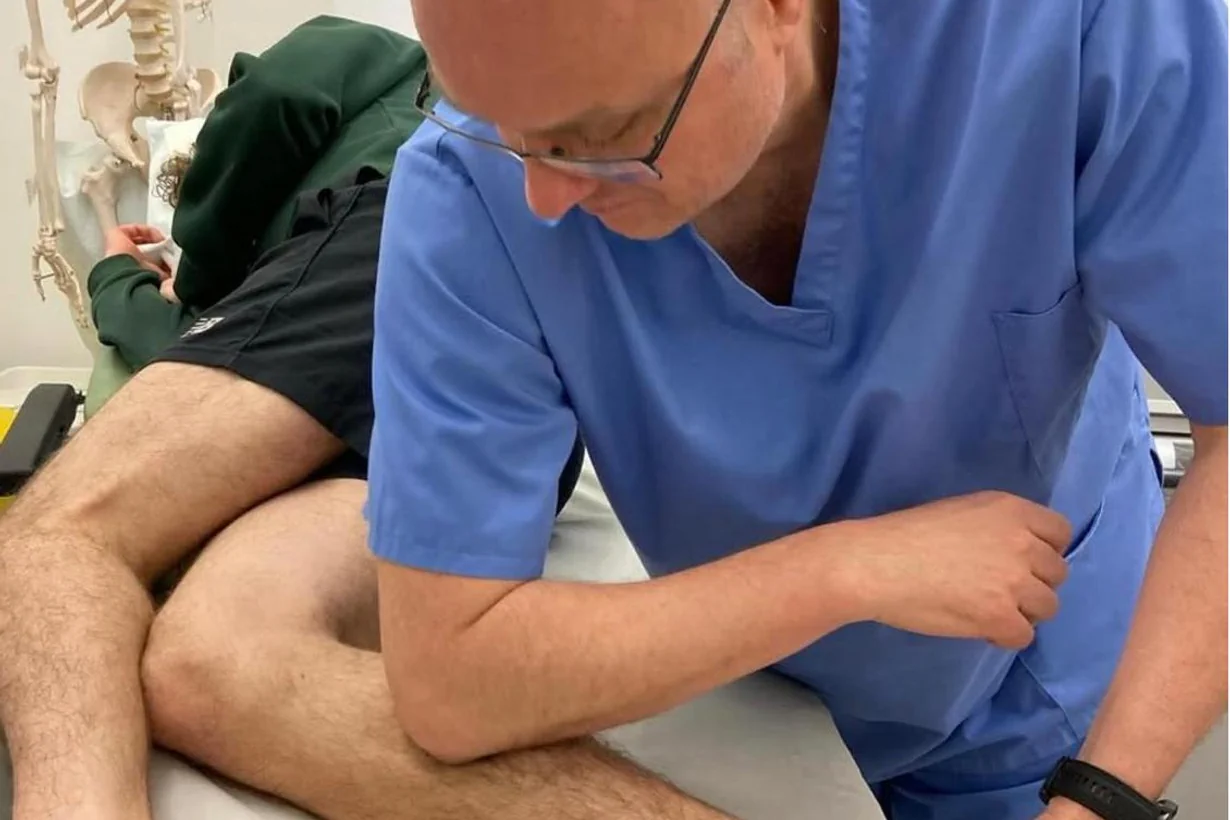 Clinician performing fascial manipulation on a patient