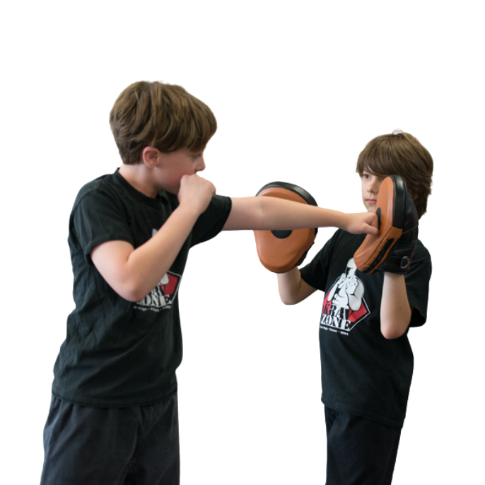 Young girl practicing kicks with help from his parent