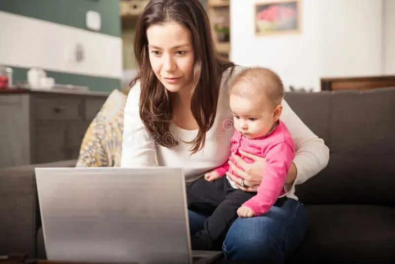 Single mom focused at her laptop, building her financial future