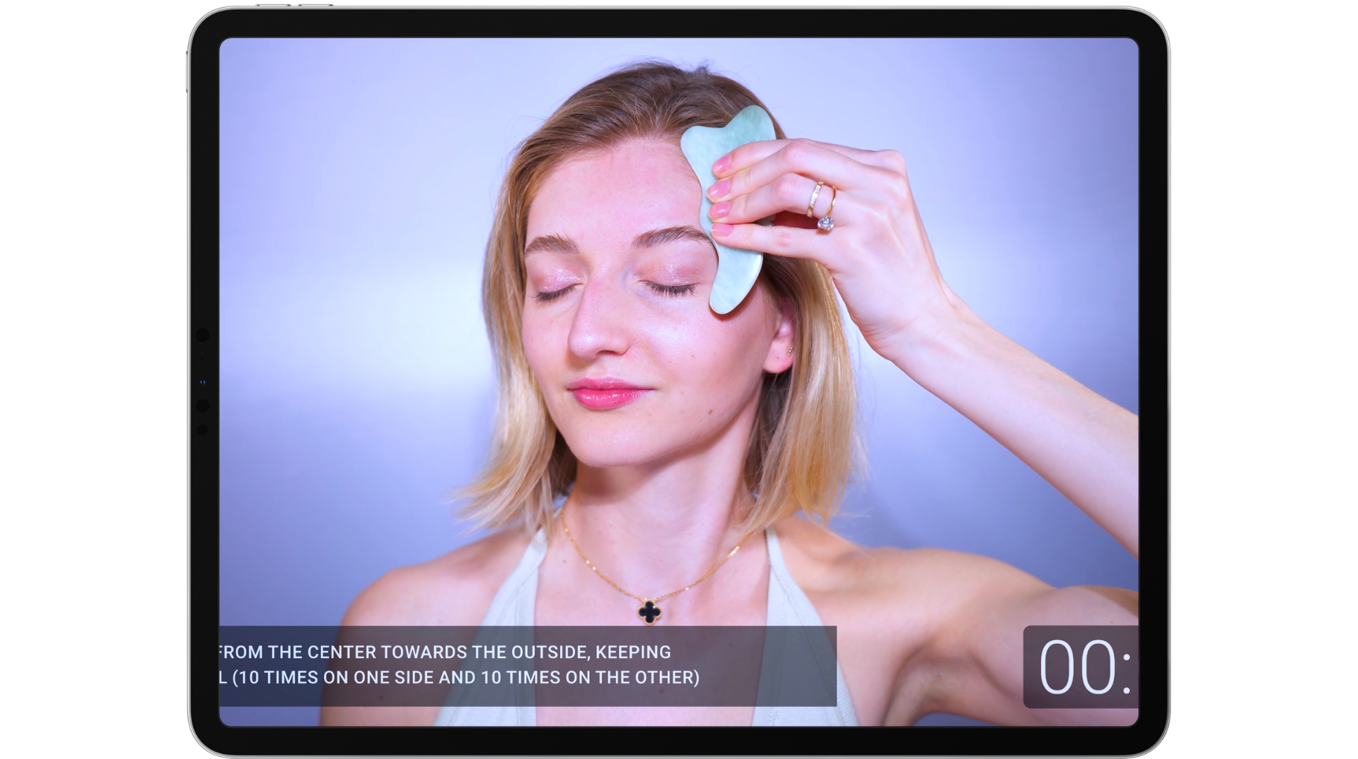 image of Valeriia using Gua Sha on her face