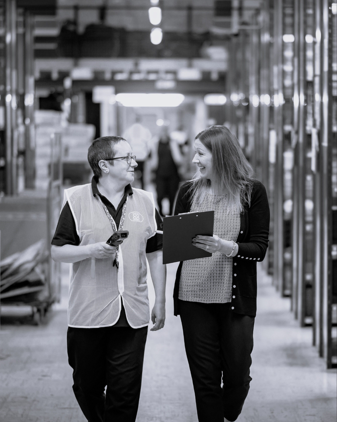 Two people talking and pointing to stairs.