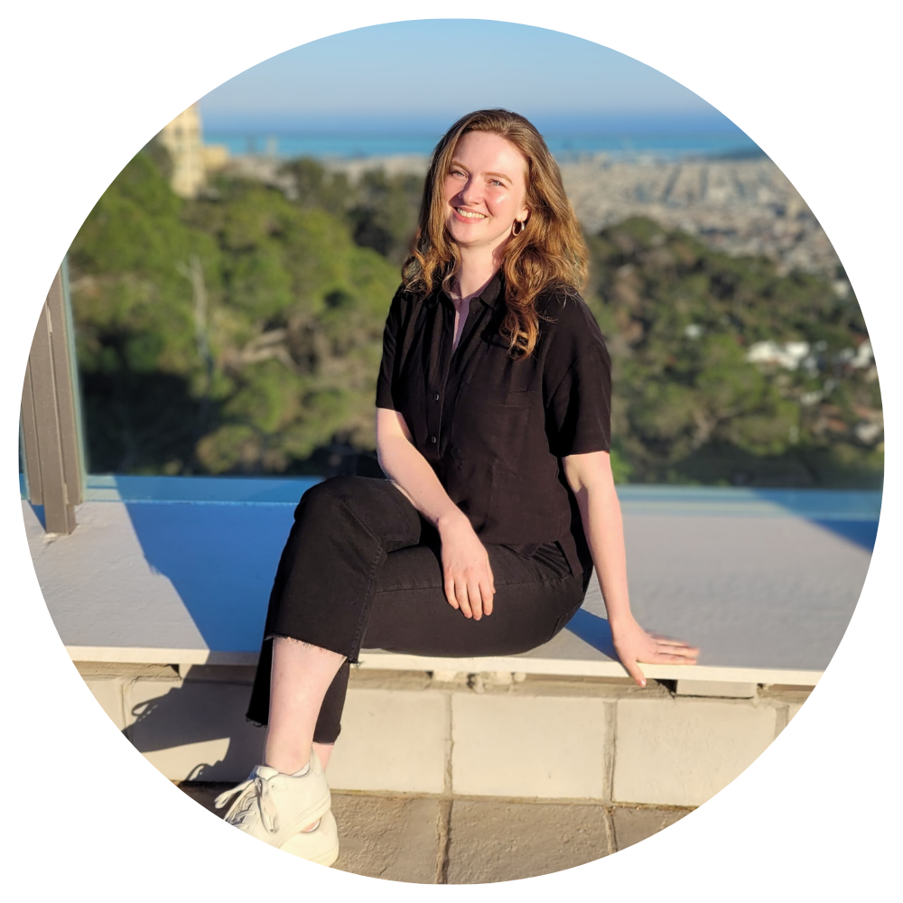 Image of Pronunciation with Emma sitting on a ledge with a view of a city behind her