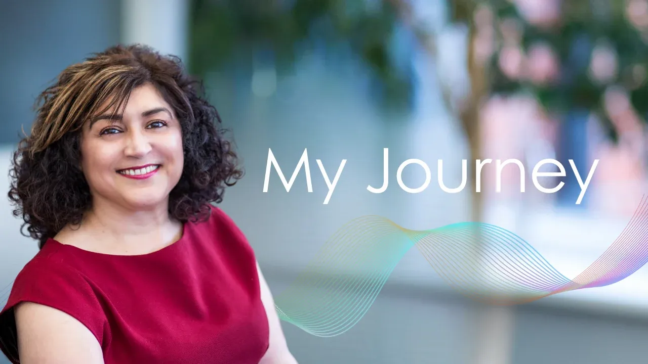 Perm Bassi Smiling at the camera and test saying My Journey