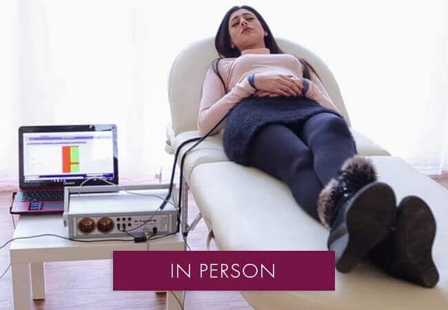 bioresonance therapy on a female client laying down relaxing whilst receiving therapylying 