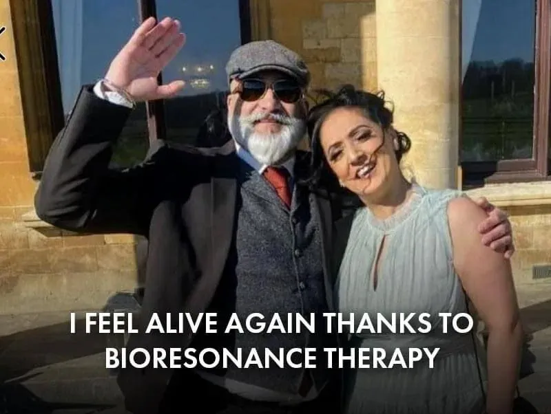 Paul, a client, with his partner, waving and a quite saying "I feel alive again thanks to bioresonance therapy'