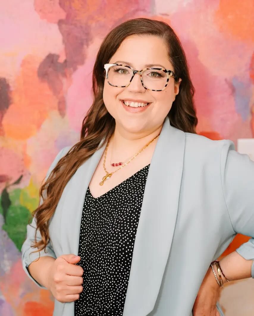 Board-certified obesity medicine physician smiling in her Indianapolis office