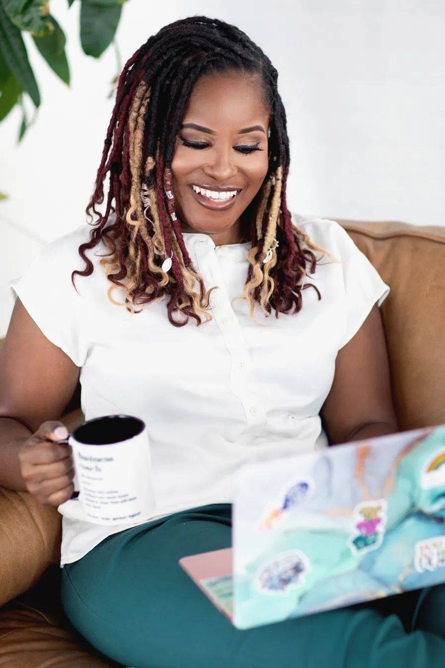 Yvette Howard smiling with her laptop