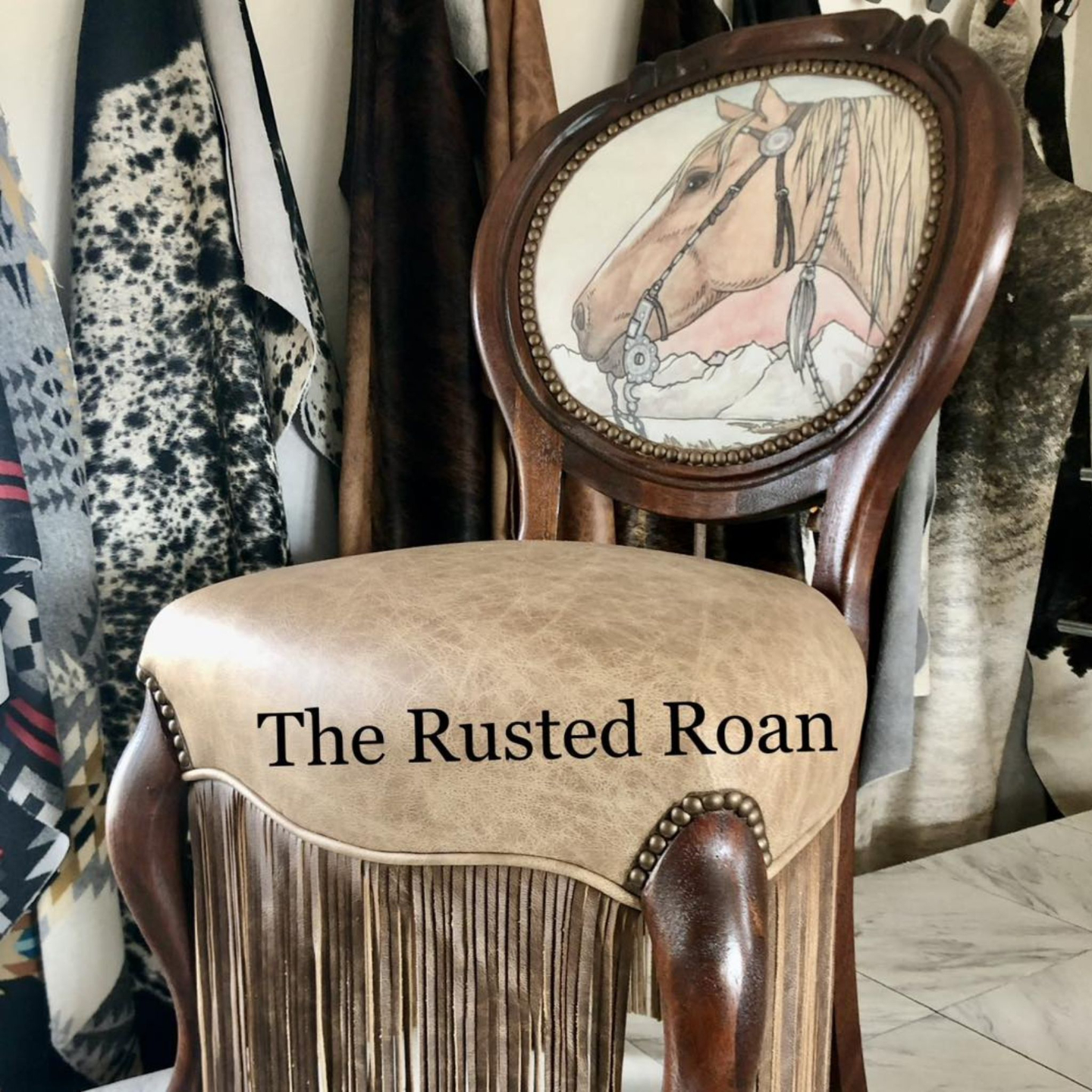 The horse chair upholstered with a Amanda Wentz artwork, leather seat and leather fringe