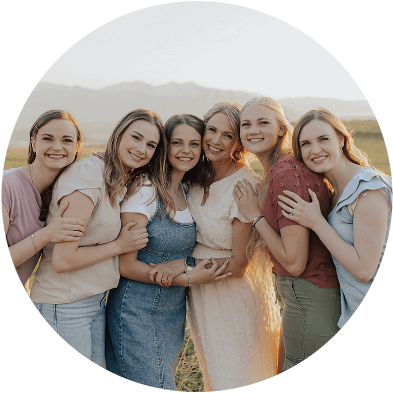 Steph Chaffee and daughters embracing and posing together in a field during golden hour, symbolizing reconnection and bonding