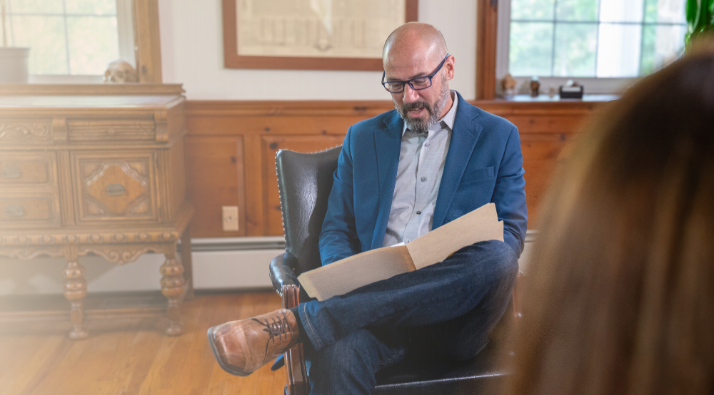Dr. Andrew Neville reviewing patient notes during a consultation.