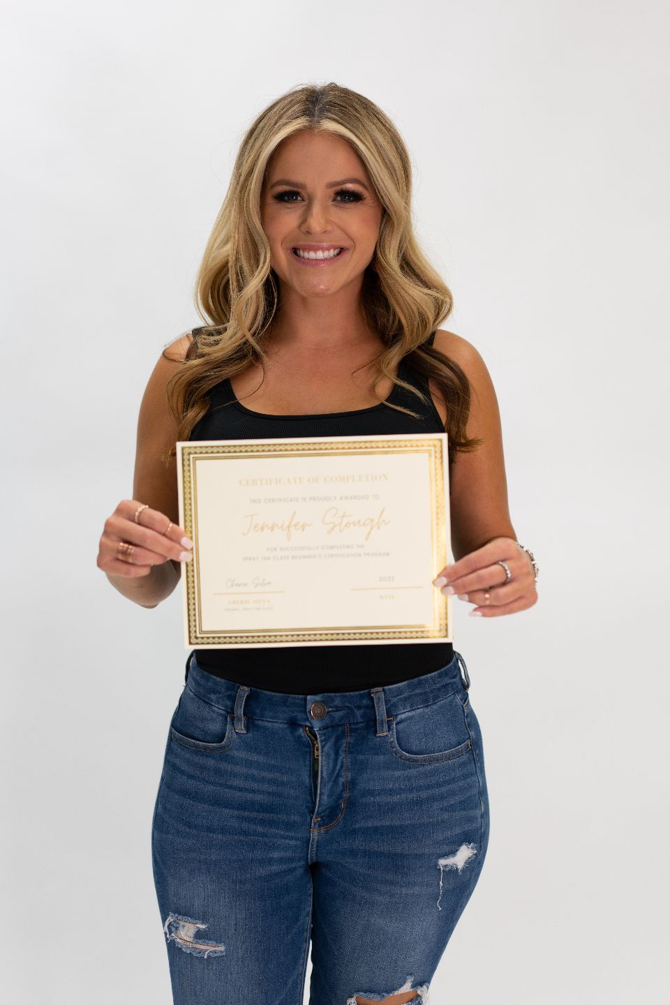 Proud X-Tan Sunless graduate posing after completing certification.
