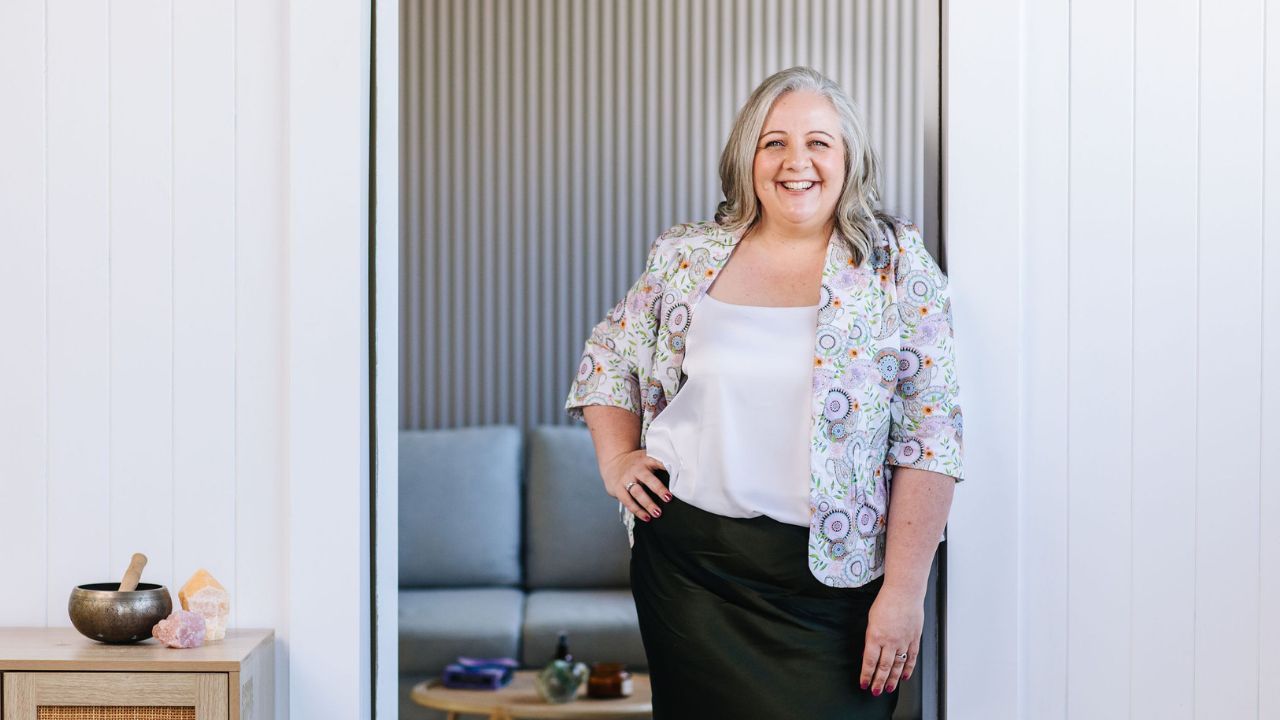 Nicki Kuurman standing in a doorway smiling