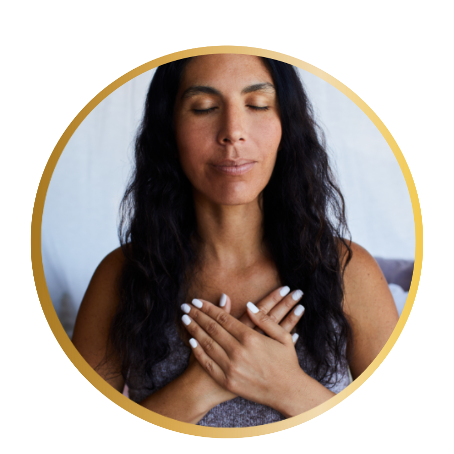 A Latina woman closes her eyes while her hands are on her heart