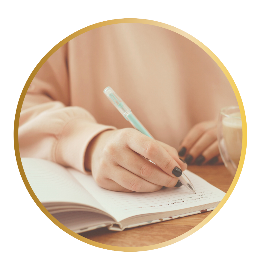 A closeup of a person writing in a journal
