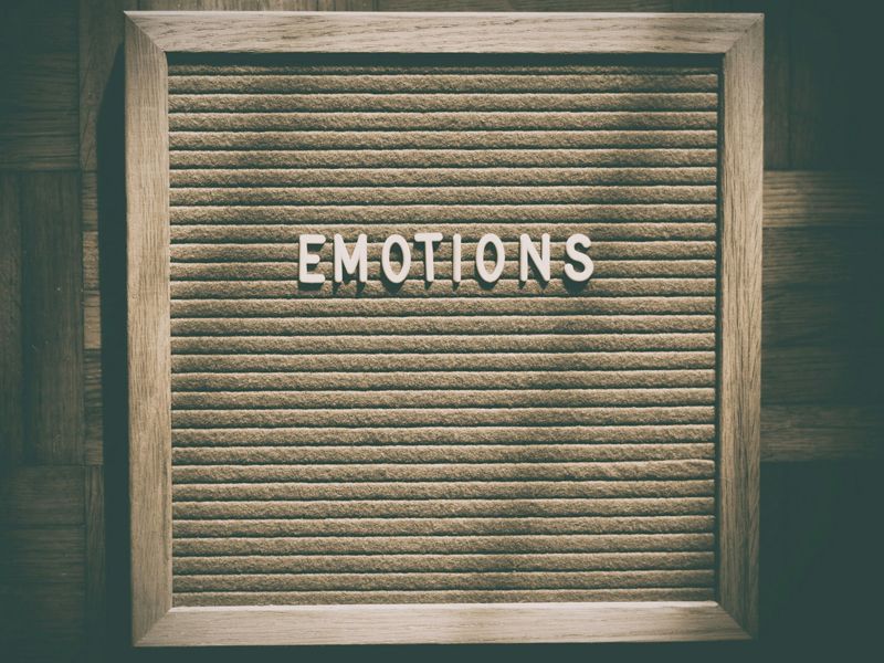 Wooden framed sign showing the word “Emotions” — representing the calming and balancing emotional reset achieved through hypnotherapy at Retrained Minds.