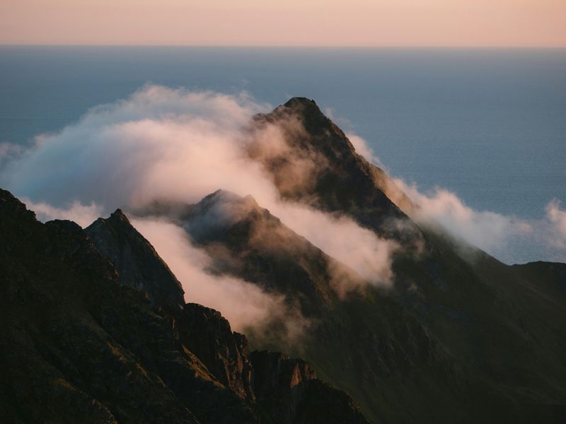 Misty mountain peak at sunrise symbolising calm, strength, and grounding for The Mountain Breath guided hypnotherapy meditation by Retrained Minds Hypnotherapy.