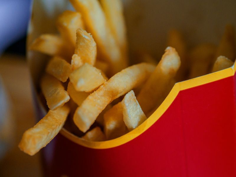 Close-up of fries in a red carton, symbolising food cravings, temptation, and the challenge of maintaining healthy eating habits - Retrained Minds Hypnotherapy.