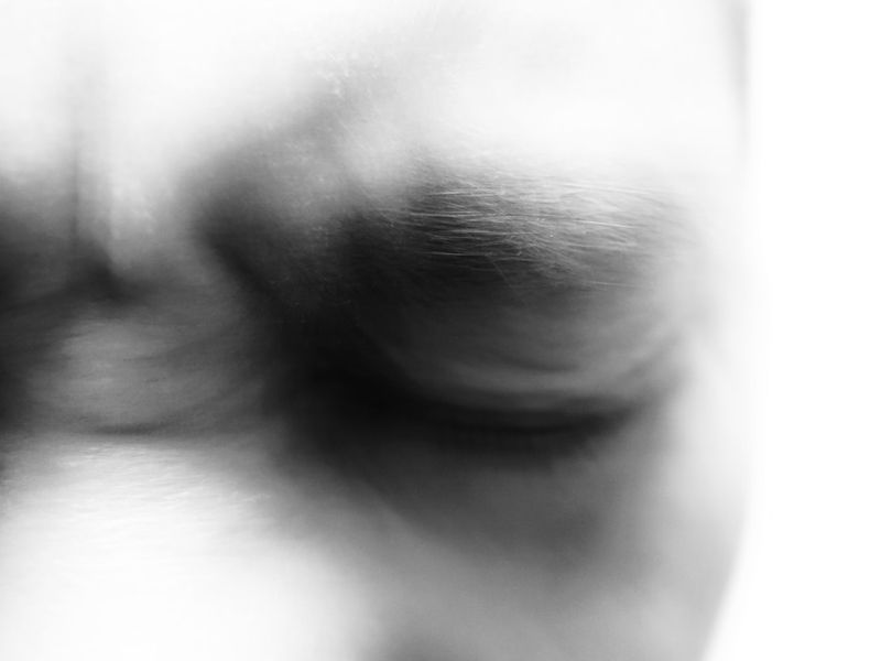 Soft blurred close-up of a closed eye symbolising release from pain, calm awareness, and the soothing relief achieved through hypnotherapy.