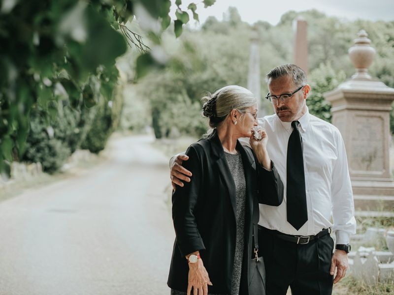 Man comforting a woman after loss, symbolising empathy, support, and emotional healing through hypnotherapy.