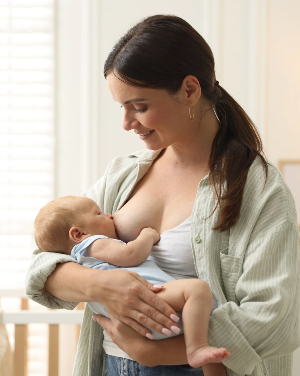 Mother Breastfeeding Her Baby Smiling
