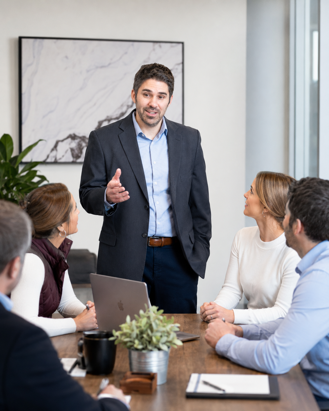 Joe Camarlinghi coaching a small group of business professionals in an office setting