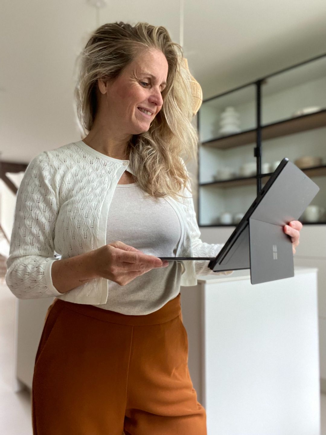 Sharon Hanegraaf achter een laptop met de tekst: Toen werd Raafwerk Business geboren. Een reis naar bewust opschalen en het creëren van een duurzame en impactvolle business