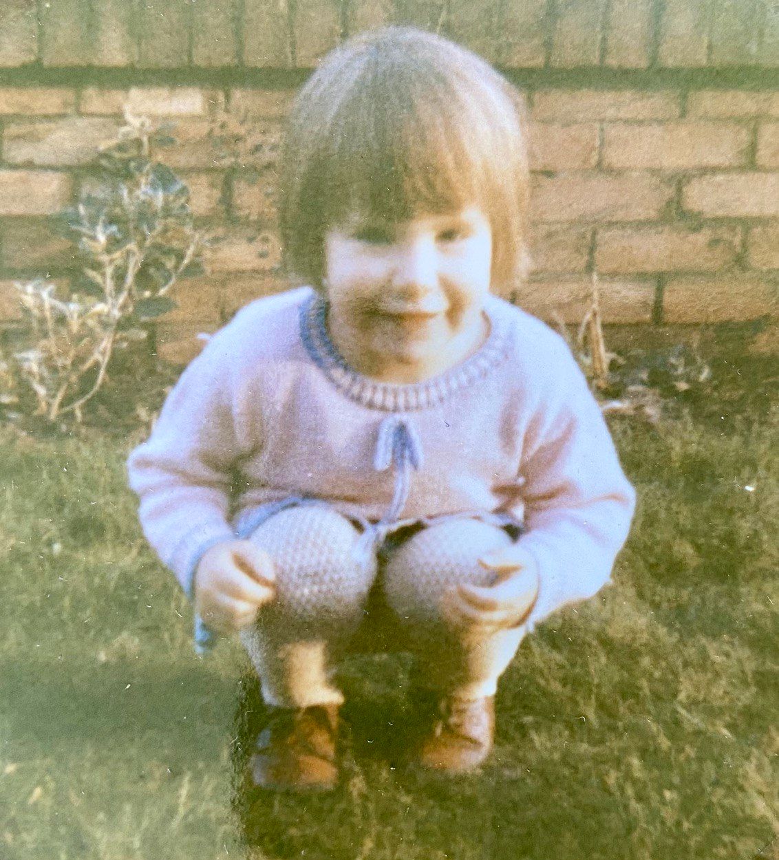 A younger Jane McCampbell Stuart in a purple sweater during her early career years before becoming an international trauma therapist | international therapist | trauma therapy for high achievers | international therapy and coaching