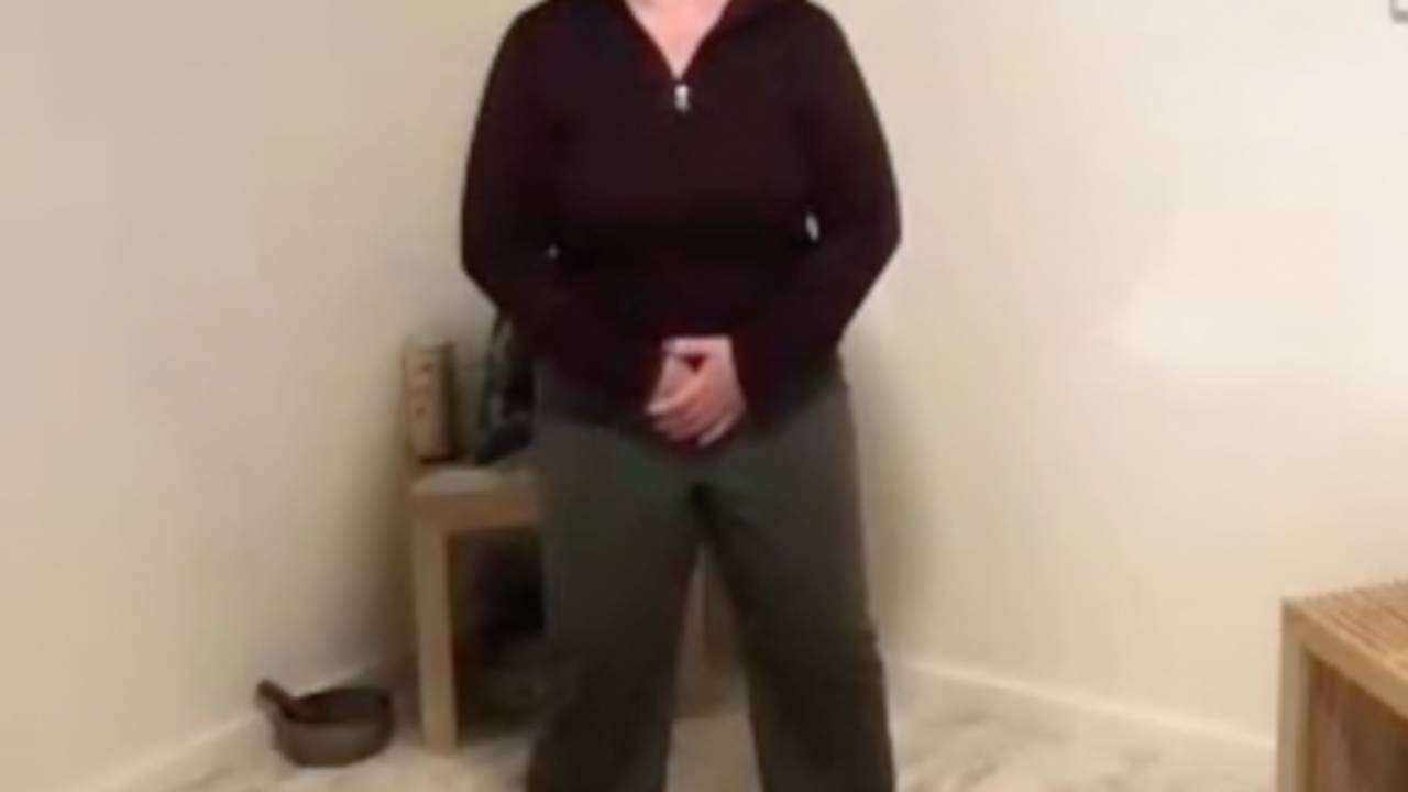 women in medical qigong posture with right hand (Yáng) closest to the body, with the left hand (Yīn) on top.