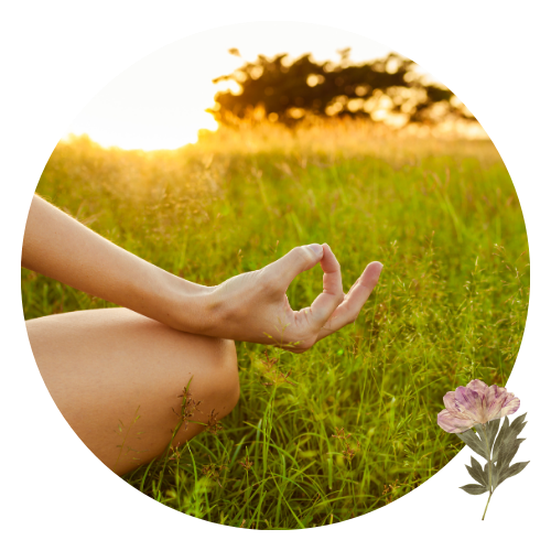 close up image of a woman's hand and knee- she is meditating