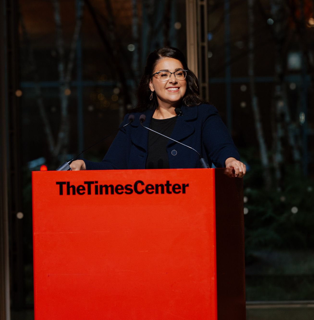 Woman speaking on stage