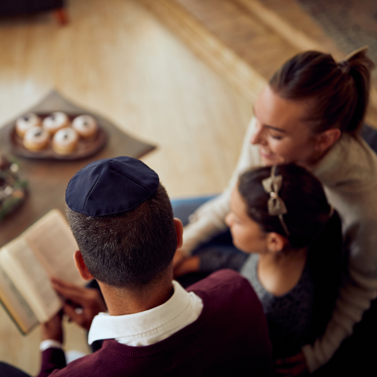 Overhead shot of a Jewish family reading a book