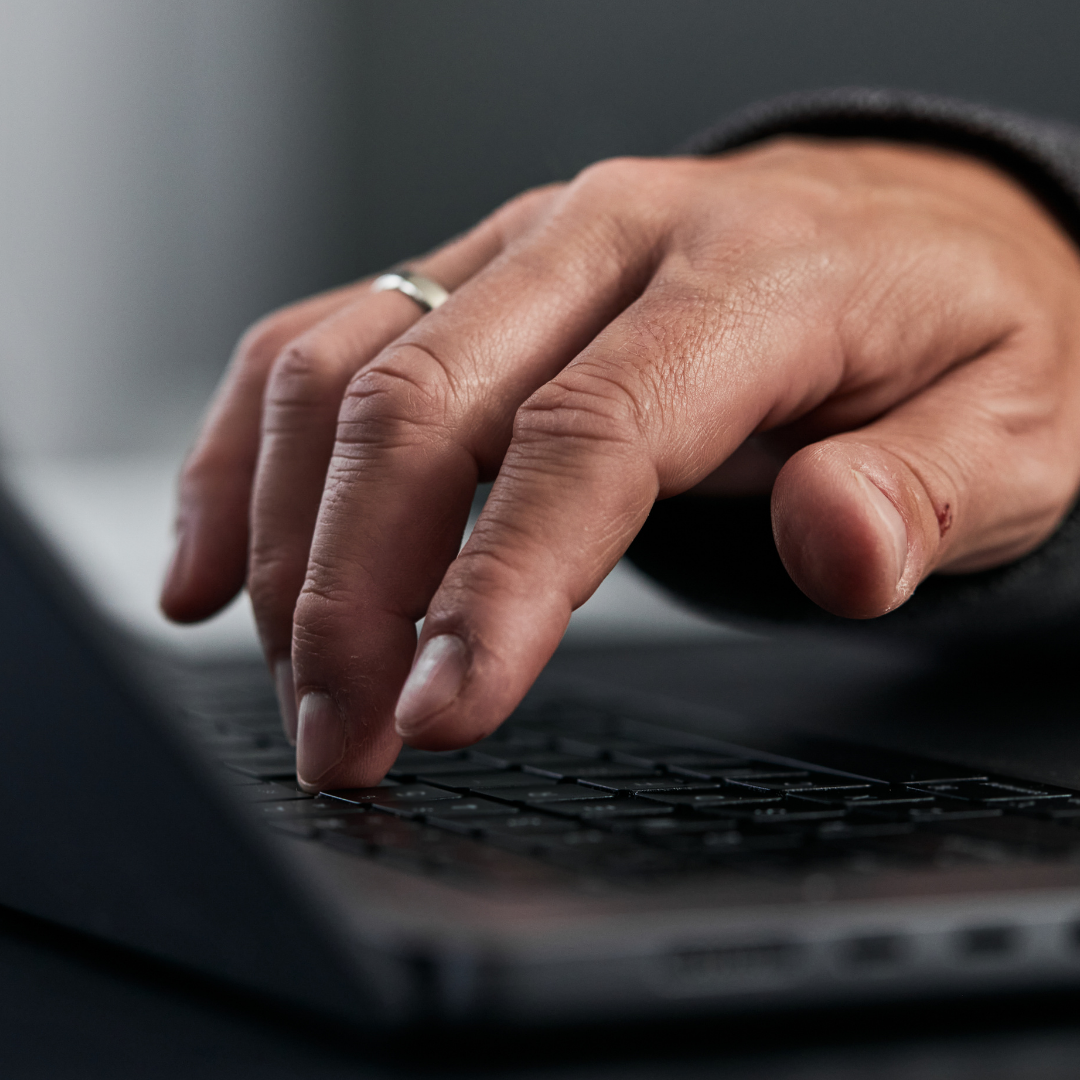 Close up of a women typing on a keyboard