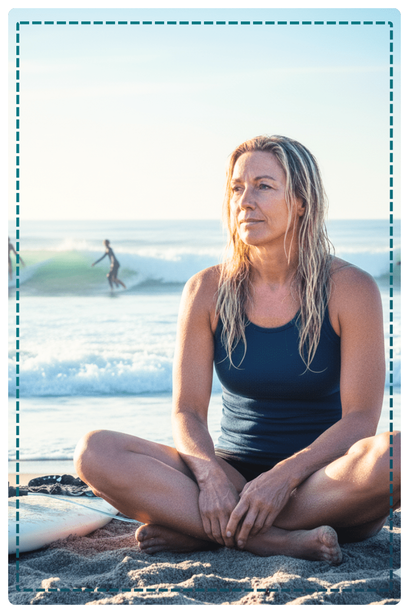 Woman surfer sitting out swells